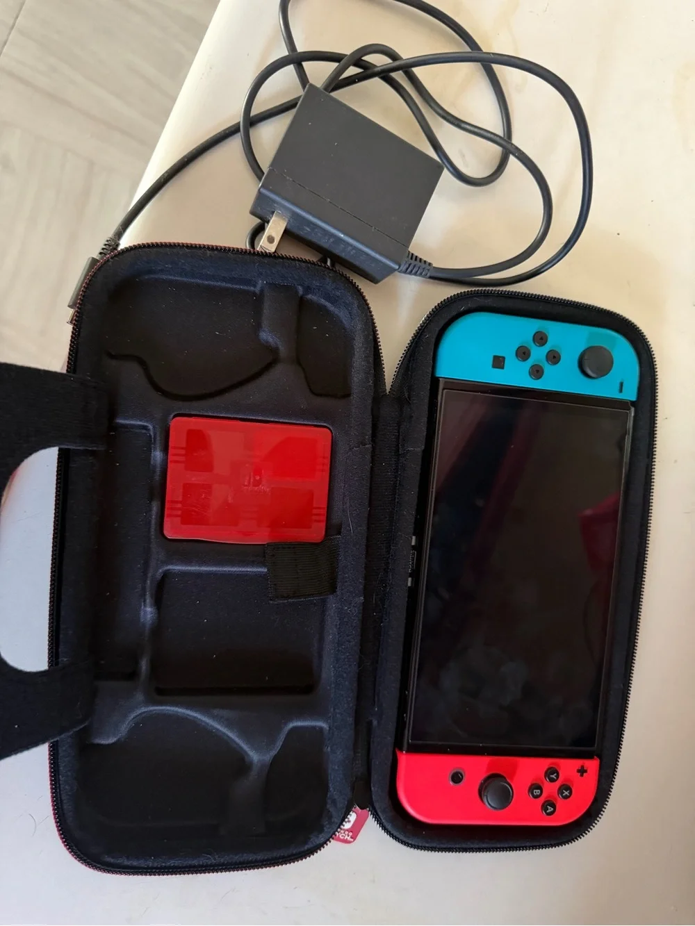 Nintendo Switch OLED with Blue Right Joy-Con & Red Left Joy-Con in Travel Case